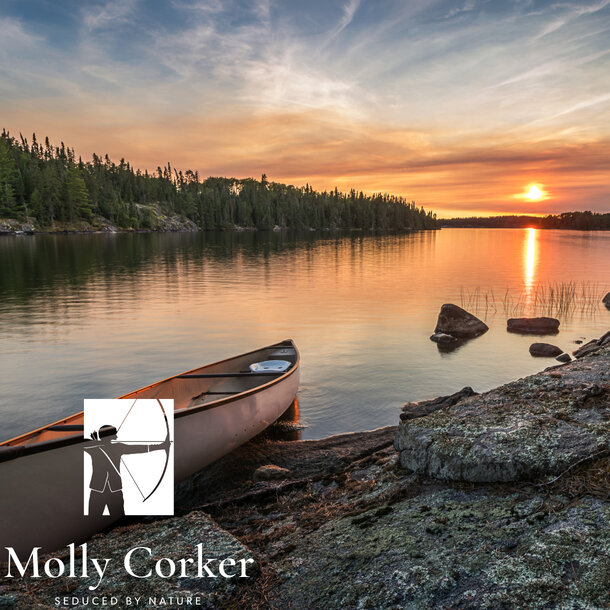 A,Lone,Canoe,On,Shore,At,A,Peaceful,Lake,At